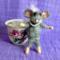 Little mouse comes out of her cup